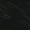 From below of bright glowing stars in long exposure on dark night sky